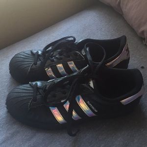 black adidas with iridescent stripes